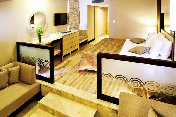 Suite-Zimmer im Melas Holiday Village mit Bett, Schreibtisch und Sofa