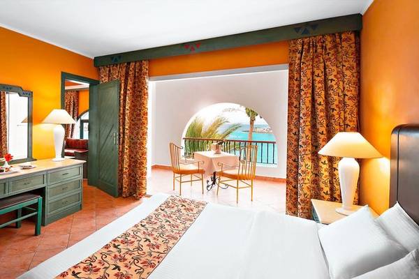 Hotelzimmer im Arabia Azur Resort mit Blick auf den Ozean, inklusive Bett, Schreibtisch und Balkon.