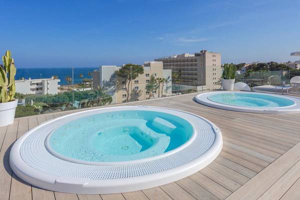 Zwei Whirlpools auf dem Dach eines Hotels mit Blick auf das Meer.