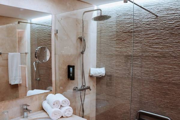 Badezimmer im Aparthotel Marins Playa mit Duschbereich, Waschbecken und Handtüchern.