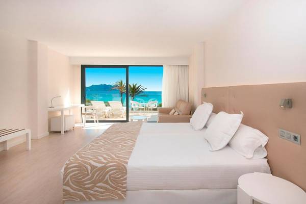 Innenansicht eines Hotelzimmers im Iberostar Cala Millor mit Meerblick, hellem Interieur und bequemem Bett.