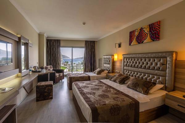 Hotelzimmer des Green Nature Diamond mit zwei Betten, Blick auf das Meer und moderner Einrichtung.