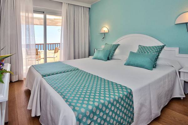 Doppelbettzimmer im Hovima Jardin Caleta Hotel mit Blick auf die Terrasse und das Meer.