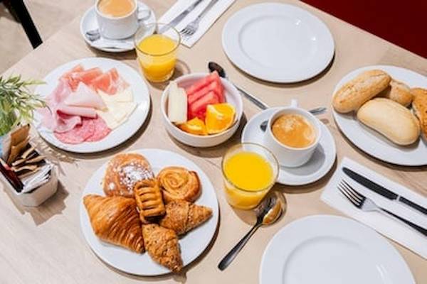 Frühstückstisch im DWO Valencia mit verschiedenen Speisen und Getränken.