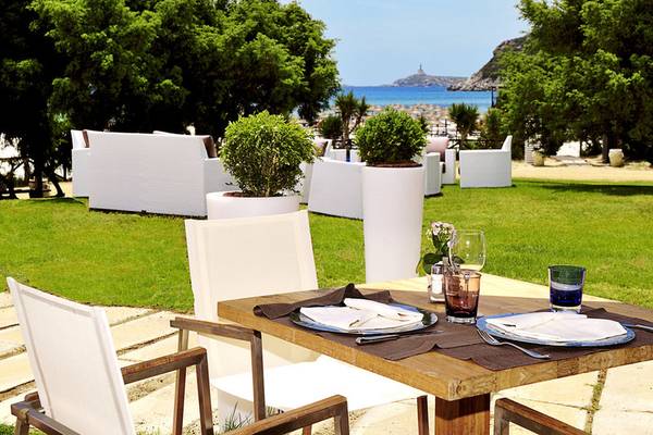Gartentisch des Almar Timi Ama Resort & Spa mit Blick auf den Strand und das Meer.