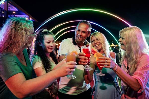 Gruppe von Gästen im Magic Life Jacaranda Hotel beim abendlichen Cocktail