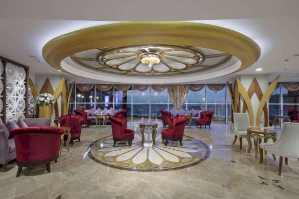 Lobby des Granada Luxury Okurcalar Hotels mit zentraler Blumendecke und luxuriösen Möbeln.
