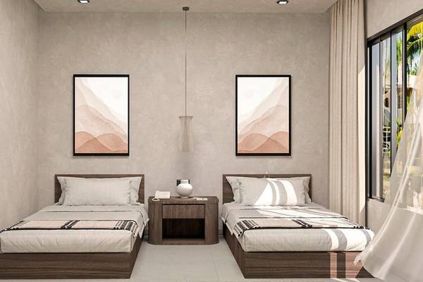 Zwei Betten mit weißen Kissen in einem modernen Schlafzimmer, das zum Aldiana Club Naga Bay gehört.
