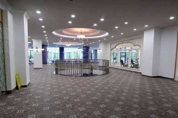 Lobby des Alan Xafira Deluxe Resort & Spa mit geometrischem Bodenmuster und zentraler Wendeltreppe