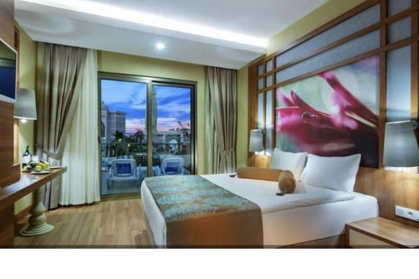 Hotelzimmer mit Balkon und Aussicht auf den Poolbereich
