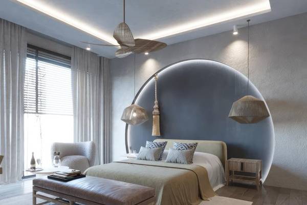 Innenansicht eines Schlafzimmers im Ethno Belek Hotel mit Halbkreiswand, Bett, Nachttischen und Wohnzimmermöbeln.