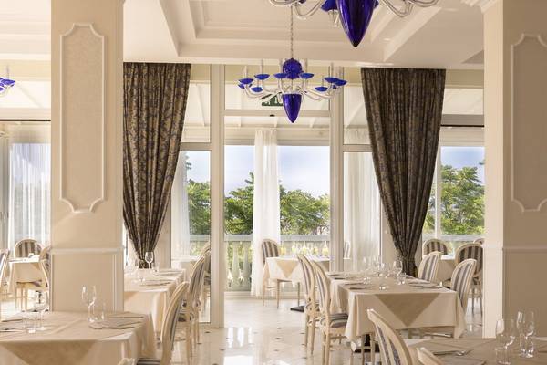 Restaurant im Baia Imperiale Hotel mit Tisch und Stühlen, Blick auf Terrasse und Bäume