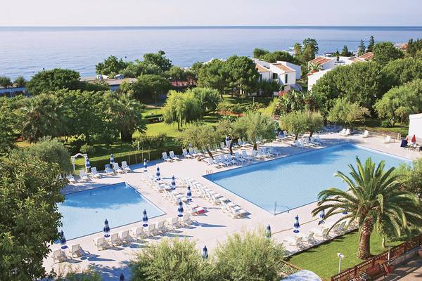 UNAHOTELS Naxos Beach Sicilia Außenpoolbereich mit Meerblick und Sonnenliegen.
