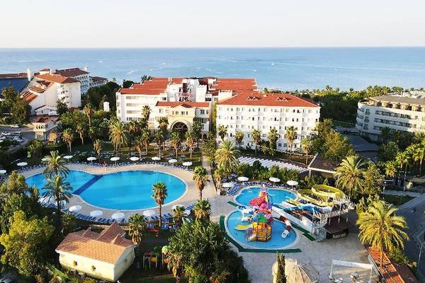 Luftaufnahme des Cesars Side Resort Hotels mit großem Swimmingpool, Wasserrutschen und mehreren Gebäuden am Meer