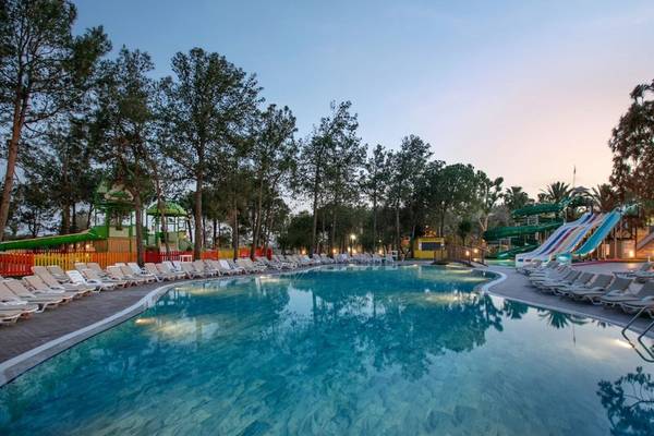Außenpool des Megasaray Resort Side bei Dämmerung mit Wasserrutschen und Liegestühlen