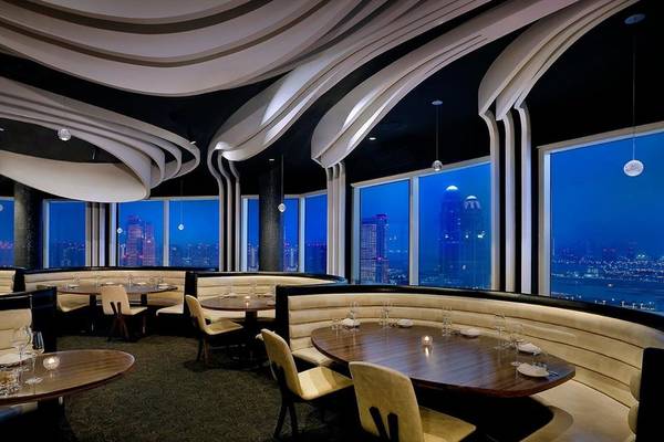 Innenansicht des Restaurants im Ritz-Carlton Doha bei Nacht mit Blick auf die Stadt