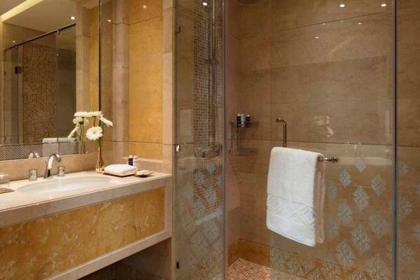 Badezimmer im Al Najada Doha Hotel by Tivoli mit fließender Dusche und Waschbecken