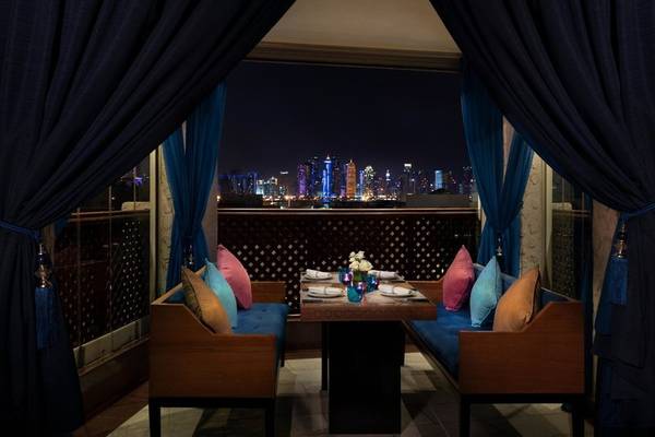 Innenbereich des Souq Waqif Boutique Hotels mit Sitzplatz und Blick auf die Nachtstadt