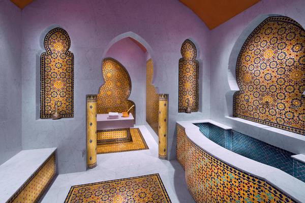 Innenansicht des Hammams im Souq Waqif Boutique Hotels mit farbigen Fliesen und Marmorwänden.