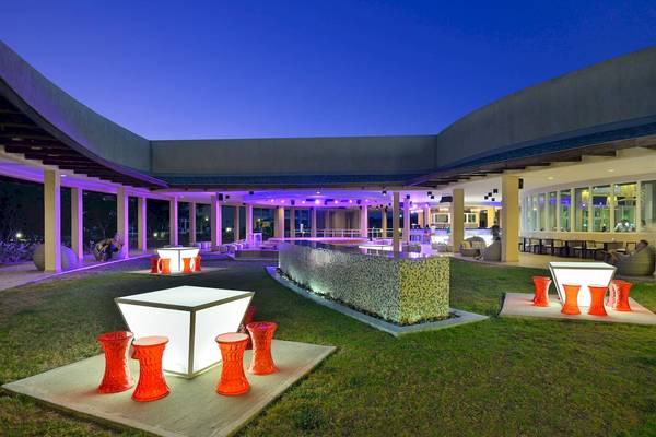 Abendansicht des Außenbereichs des Paradisus Varadero Resort & Spa mit Beleuchtung und Möbeln.