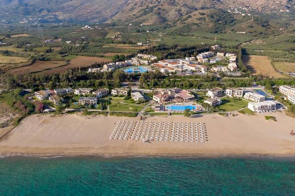 Luftaufnahme des Pilot Beach Resorts mit vielen Gebäuden und Swimmingpools am Strand