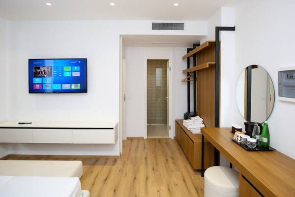 Hotelzimmer mit Fernseher, Schreibtisch und Bad im Oricon Coast Luxury Resort.