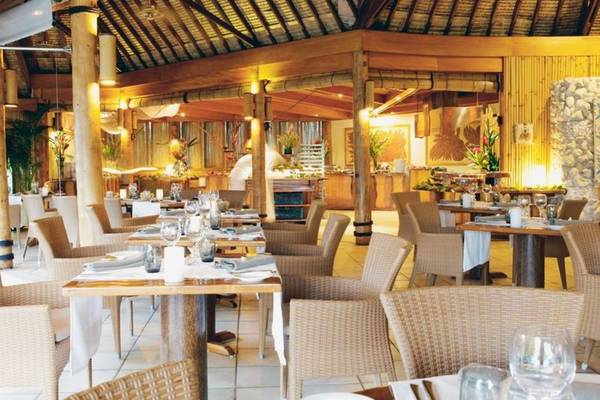 Innenansicht des Restaurants im Le Bora Bora by Pearl Resorts mit gedeckten Tischen und Stühlen.