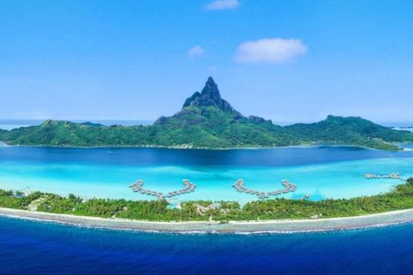 Luftaufnahme des InterContinental Bora Bora Resorts mit kristallklarem Wasser und grüner Insel.