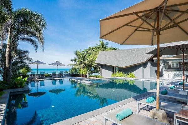 Außenpool mit Lounge-Bereich und Sonnenschirmen am KC Grande Resort Koh Chang.
