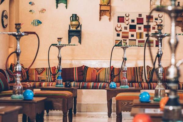 Loungebereich im Iberostar Selection Royal El Mansour Hotel mit bunten Kissen und mehreren Shishas.