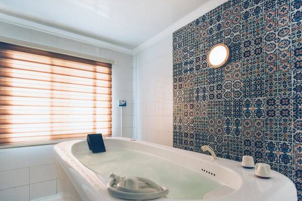Badezimmer mit Badewanne und blauen Fliesenwand im Iberostar Selection Royal El Mansour Hotel