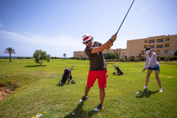 Golfspieler auf einem Golfplatz vor dem Nour Palace Resort & Thalasso Hotel.