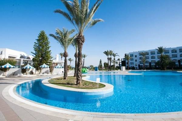 Außenpool des Mahdia Palace Thalasso Hotels mit weißen Gebäuden und Palmen