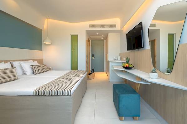 Innenansicht eines Hotelzimmers im Arina Beach Resort mit Doppelbett, Dekor und Möbeln.