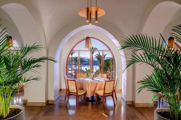 Innenbereich des Mövenpick Resorts El Quseir mit Esstisch und Blick auf das Meer