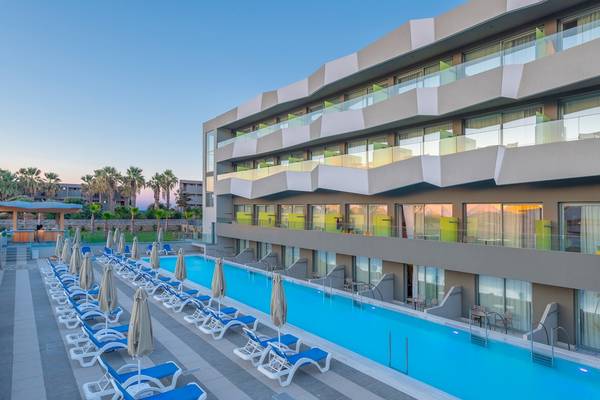 Außenbereich des Arina Beach Resorts mit Swimmingpool, Sonnenliegen und Palmen