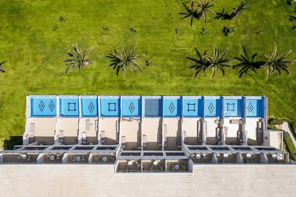 Luftaufnahme des Vantaris Palace mit Swimmingpools und Palmen im Hintergrund.