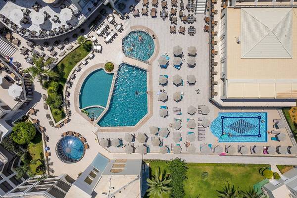 Luftaufnahme des Vantaris Palace mit mehreren Swimmingpools und Sonnenliegen.