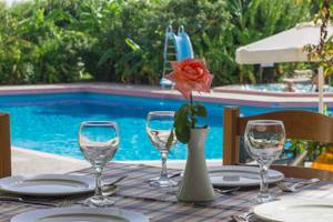 Ein Tisch im Irene Palace Beach Resort mit einem Pool im Hintergrund.