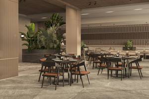 Innenbereich des Jaz Elite Amara Hotels mit Tisch und Stühlen, umgeben von Pflanzen.
