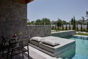 Terrasse im Atlantica Beach Resort Kos mit Liegebett und Swimmingpool.