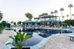 Außenpool des Anonymous Beach Hotels mit Lounge-Stühlen und Sonnenschirmen.