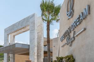 Eingang des Cretan Dream Resort & Spa mit Palme und moderner Architektur