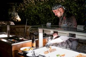 Ein Koch bereitet im Cretan Dream Resort & Spa ein Gericht zu.
