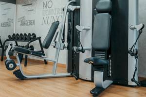 Fitnessstudio im LIVVO Volcan Lanzarote Hotel mit Trainingsgeräten und einer Wand mit Texten.