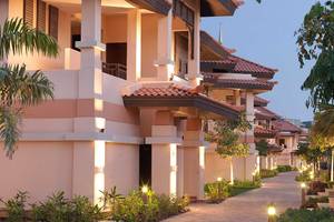 Abendansicht der Anantara The Palm Dubai Resort Villas mit illuminierten Wegen und gut beleuchteten Gebäuden.