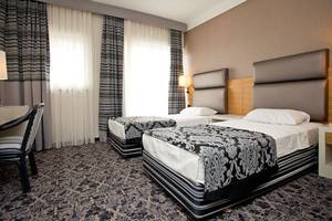 Zwei Betten mit schwarzen und weißen Mustern in einem Hotelzimmer des Cettia Beach Resort.