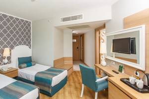 Zweibettzimmer im Sherwood Exclusive Lara Hotel mit modernen Möbeln und Dekoration.