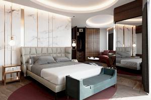 Schlafzimmerdesign im Sherwood Exclusive Lara Hotel mit Marmorwänden, Rundbett, grauen Kissen und einem runden Tisch.
