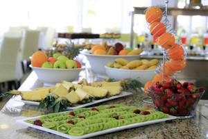 Früchtebuffet im LABRANDA Kiotari Miraluna Resort mit verschiedenen Obstsorten wie Orangen, Äpfeln, Bananen, Ananas und Kiwis.